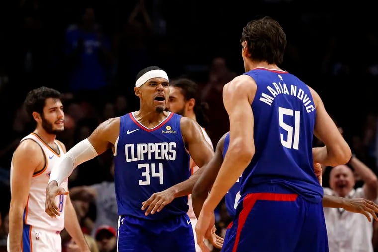 Los Angeles Clippers' Tobias Harris (34) celebrates after teammate Boban Marjanovic (51) made a shot against Oklahoma City Thunder during the second half of an NBA basketball game Friday, Oct. 19, 2018, in Los Angeles. Clipper won 108-92. (AP Photo/Ringo H.W. Chiu)