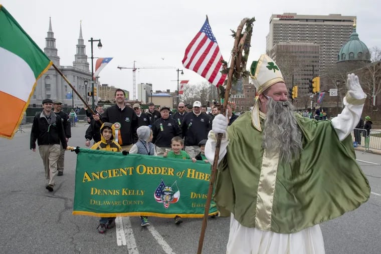 John Cooke, dressed at St. Patrick, leads members of the Ancient Order of Hibernians Div. 1 Dennis Kelly out of Havertown around Logan Circle and up the Ben Franklin Parkway during Philadelphia's annual St. Patrick's Day Parade March 13, 2016.
