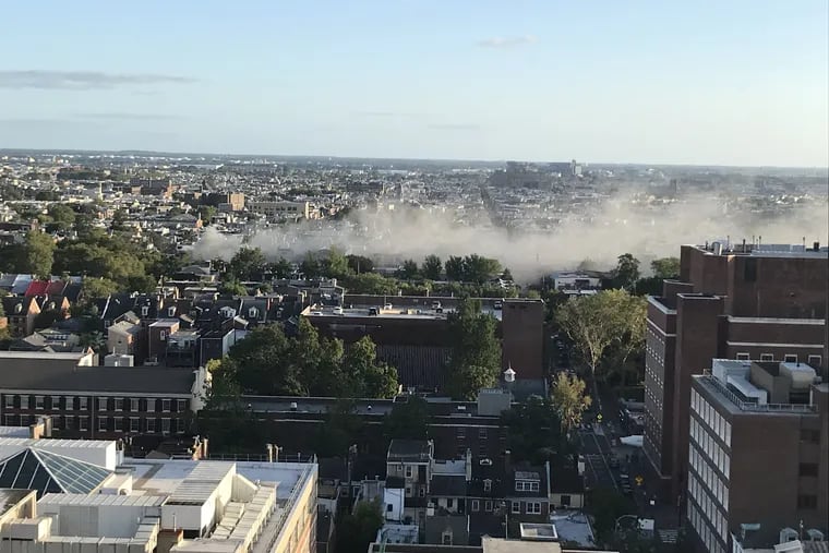 In a southern view from an apartment near Washington Square, smoke billows from the fire at Nourish at Seventh and South Streets.