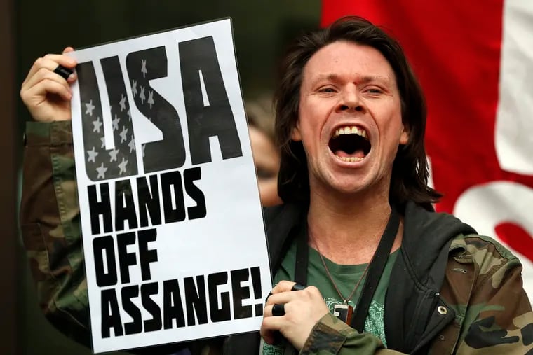 British activist Lauri Love protests at the entrance of Westminster Magistrates Court in London, Thursday, May 2, 2019. WikiLeaks founder Julian Assange is facing a court hearing over a U.S. request to extradite him for allegedly conspiring to hack a Pentagon computer. Assange is expected to appear by video link from prison for the hearing at London's Westminster Magistrates' Court.