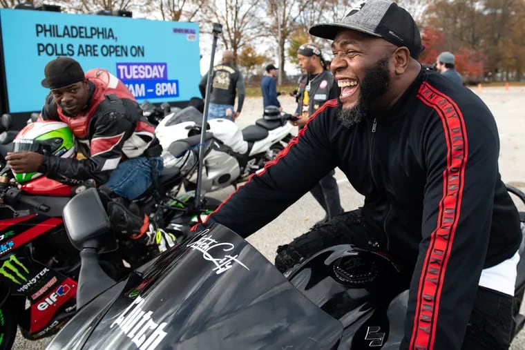 Dame Johnson (left) and “Mr. Huss” (right) sit on their motorcycles before the motorcycle ride and party at the polls event at Enon Baptist Church in Philadelphia on Saturday, Nov. 5, 2022. The event was hosted by When We All Vote and several local organizations to encourage voting in the upcoming midterm election.
