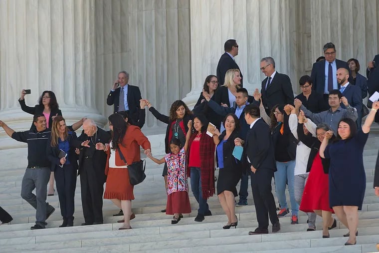 Supporters of fair immigration reform hold hands as they leave after hearing arguments at the Supreme Court in the case U.S. versus Texas in April.
