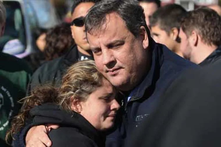 In this Nov. 3, 2012 file photo, New Jersey Gov. Chris Christie comforts Kerri Berean in Little Ferry, N.J., after Superstorm Sandy caused a tidal surge on the Hackensack River that overtook a natural berm protecting the town. (AP Photo/The Star-Ledger, David Gard, Pool, File)