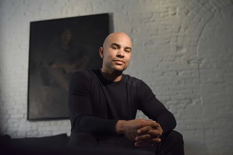 MANHATTAN, NEW YORK, MARCH 14, 2018 Philadephia 76ers basketball player Jerryd Bayless is seen in his home in Manhattan, NY. Bayless is an avid reader, art collector and is currently pursuing his undergraduate degree online. The painting behind Bayless is by  Lynette Yiadom-Boakye and entitled A Pedigree of Some Note. 3/14/2018