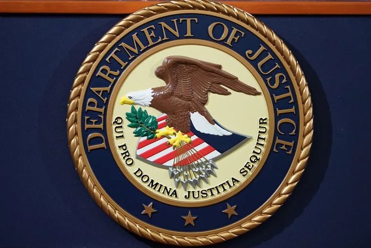 The Department of Justice seal is seen on a lectern ahead of a press conference in Washington, D.C. on Nov. 28, 2018.