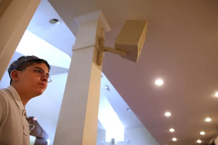 Jake Vistoso, 14, raised money to install a hearing "loop" system inside the synagogue at Congregation Brothers of Israel in Newtown for people with hearing aids. (DAVID MAIALETTI / Staff Photographer)