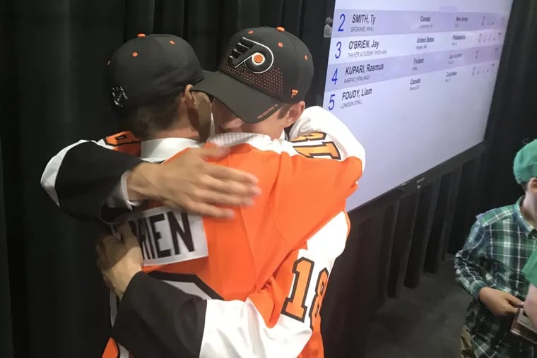 The Flyers' two first-round selections — Jay O'Brien (left) and Joel Farabee — embrace after being chosen in Friday's draft.