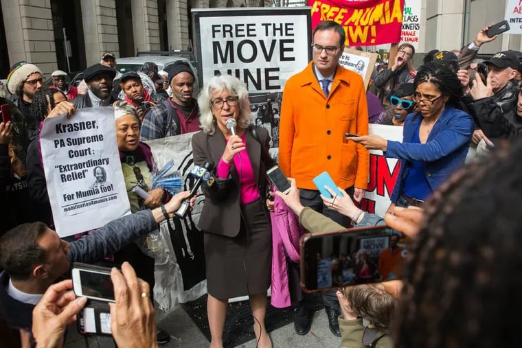 Attorneys for Abu-Jamal, Judith Ritter, center, and Samuel Spital (orange coat), speak to supporters outside the Criminal Justice Center after a hearing Monday, April 30, 2018, about a constitutional challenge in the case of convicted cop-killer Mumia Abu-Jamal.