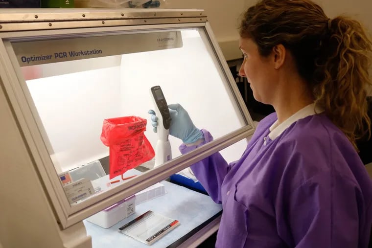 Lab technologist Kathleen Davis pipettes genetic samples that  can help guide the choice of mental-health treatments, at King of Prussia-based Genomind.