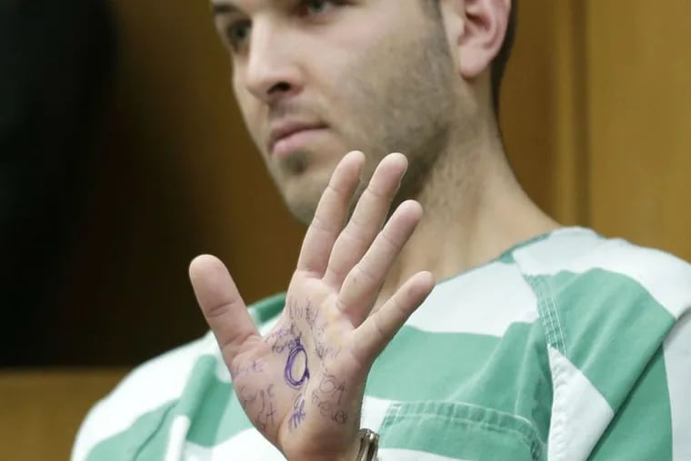 Anthony Comello displays writing on his hand during his extradition hearing in Toms River, N.J., Monday, March 18, 2019. New York City police say a suspect is in custody in the shooting death of the reputed Gambino crime family boss. Chief of Detectives Dermot Shea says 24-year-old Comello was arrested Saturday, March 16, 2019, in the death of Francesco Cali on Wednesday in front of his Staten Island home.