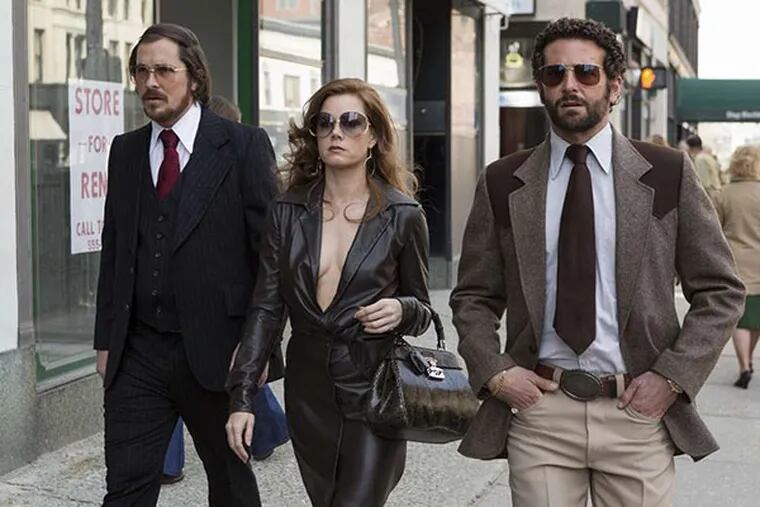 Christian Bale (left) as Irving, Amy Adams as Sydney, and Bradley Cooper as Richie DiMaso make Abscam-era fireworks.