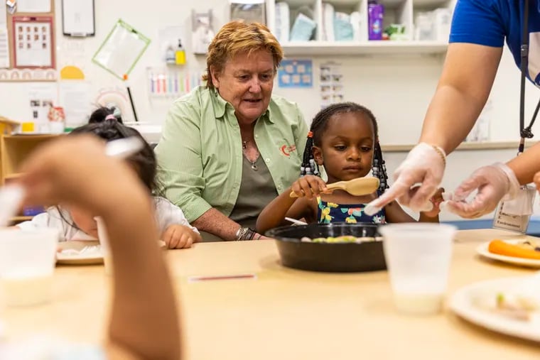 Mary Graham, executive director of Children’s Village, stops by a classroom as the children are served lunch family style in Philadelphia, Pa., on Wednesday, Aug., 16, 2023.