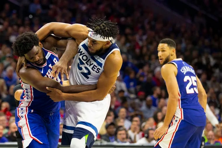 Joel Embiid (left) fights with the Minnesota Timberwolves' Karl-Anthony Towns as Ben Simmons (25) looks on.