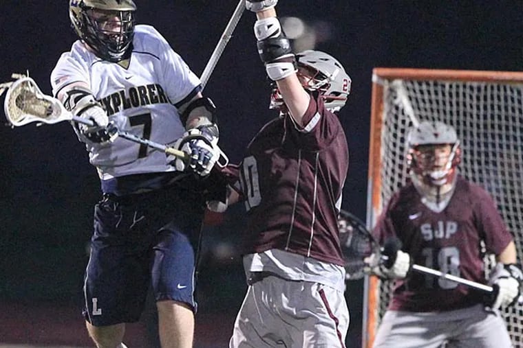 Aidan Kerrigan, left, of LaSalle leaps to catch a ball as he tries to
score in the final second of the third quarter against Ryan Neff,
center, of St. Joseph's Prep in boys' lacrosse, 7 p.m. at Plymouth
Whitemarsh on May 1, 2014.  The game was delayed by lightning att
ehstart of the 4th quarter with the score tied 5-5.    ( CHARLES FOX /
Staff Photographer )