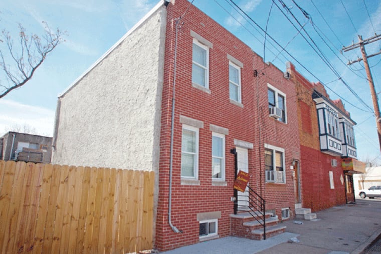 At 2014 Latona St., a single-family, two-story brick row home, a wall was bowed, making the building unsafe. Thursday, March 19, 2015.