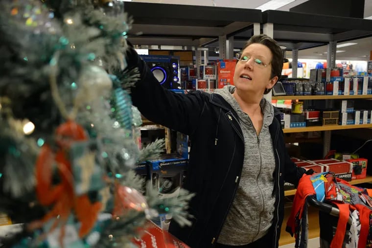 Pat Ficarotta shops in the holiday section at Kohl’s in Yardley. Many such retailers plan to add seasonal jobs. (WILLIAM THOMAS CAIN/For The Inquirer)
