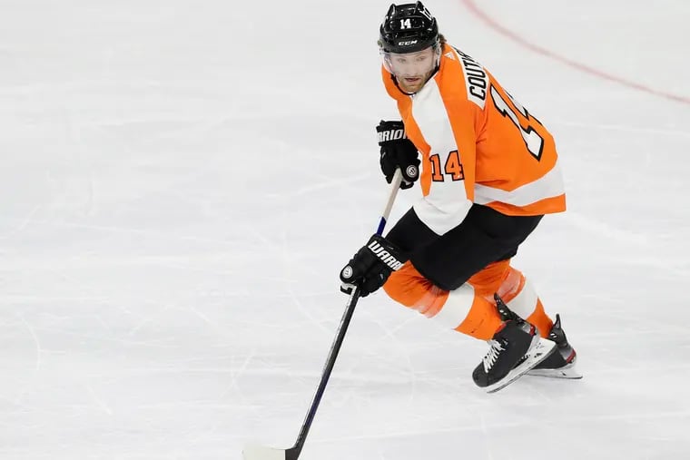 Flyers center Sean Couturier skates with the puck against the Pittsburgh Penguins in the Flyers' season-opening win Jan. 13, 2021 in Philadelphia. He was injured on his first shift in Game 2 on Friday.