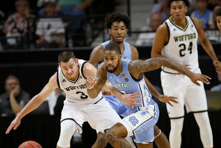 Wofford's Fletcher Magee (3) trying to hold off North Carolina's Seventh Woods (0) in pursuit of a loose ball during a game in November.