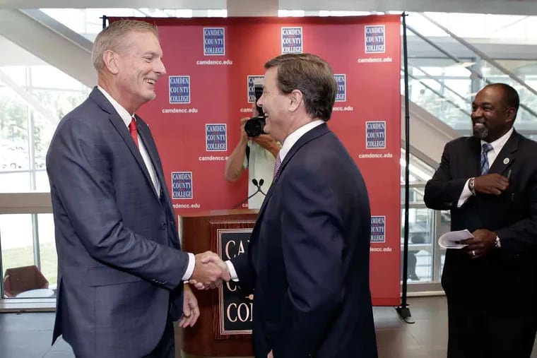 Camden County College President Don Borden (left) is congratulated by U.S. Rep. Donald Norcross after a press conference in Taft Hall on the Blackwood campus.