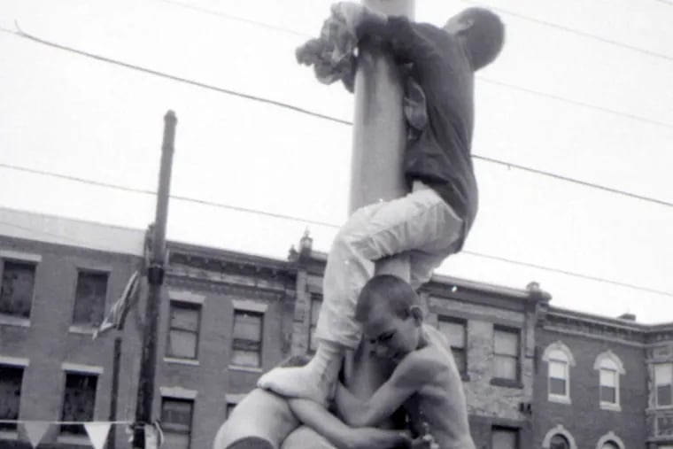 It takes teamwork: A 1992 attempt at getting the prizes at the top of the pole.