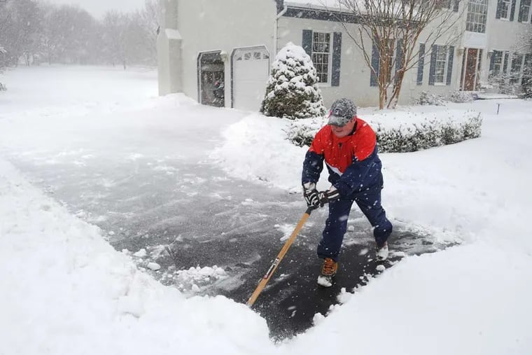 Rich Maley has a hard time keeping up with the falling snow as he shovels his driveway in Thornton, PA March 5, 2015.  About five inches of snow had fallen by 10:30 am with as much as eight inches forecast.  ( CLEM MURRAY / Staff Photographer )