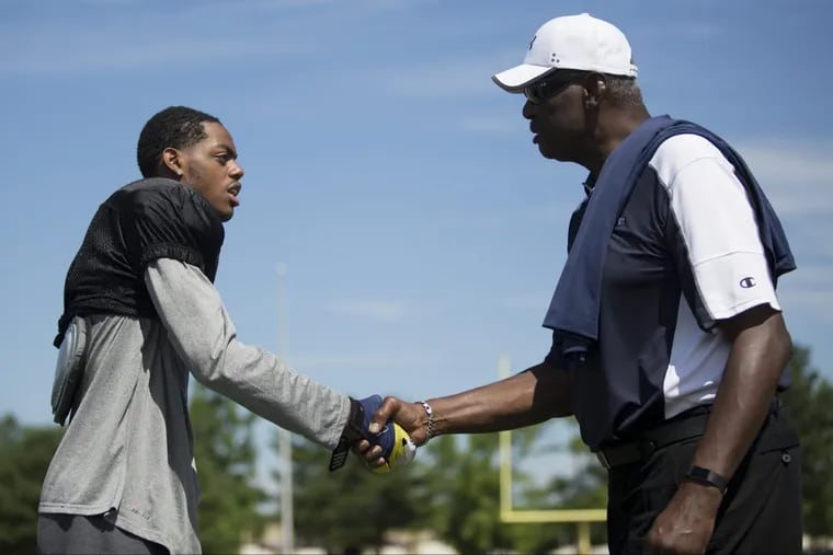 Eagles great Harold Carmichael, an honorary coach at the Taliaferro Classic, greets Isaiah Anfield of Camden High.