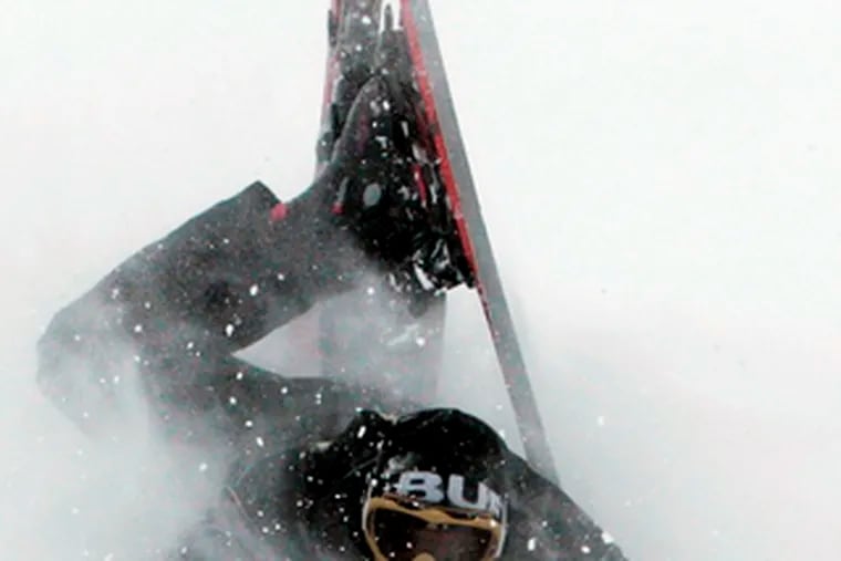 Skier Mike McConnell wipes out in Keystone, Colo. Winter storms battered the region. See more on Page A7.