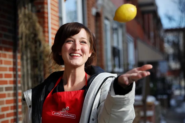 Caity Rietzen, library supervisor for the Free Library of Philadelphia's Culinary Literacy Center, stands for a portrait outside her South Philadelphia home on Friday, Dec. 18, 2020.