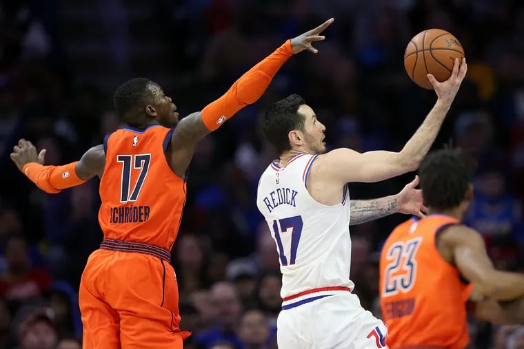 The Sixers' JJ Redick (17) puts the ball up past the Oklahoma City Thunder's Dennis Schroder (17) during a game at the Wells Fargo Center in South Philadelphia on Saturday, Jan. 19, 2019. The Sixers lost 117-115.