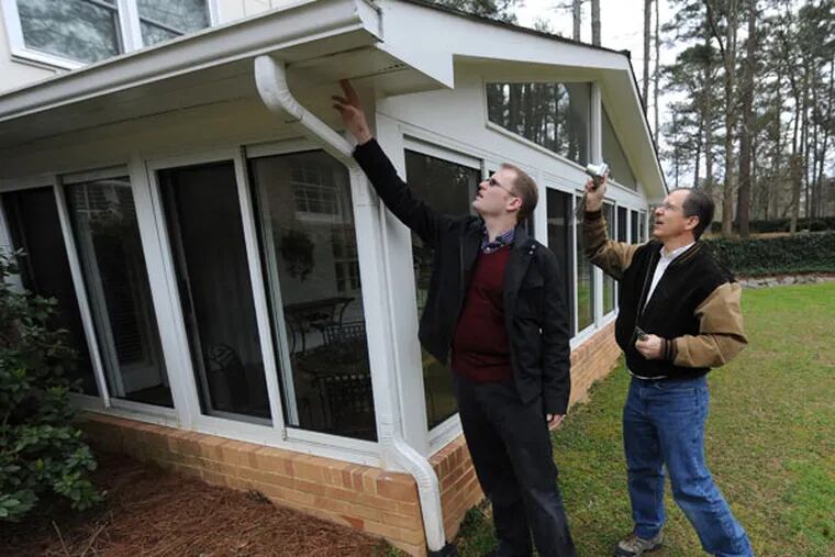 Atlanta Journal-Constitution reporter Scott Trubey, left, and home inspector Tom Gotschall inspect a home in Dunwoody, Georgia, March 26, 2013. Trubey takes readers through his personal experience of buying a home. He and his wife went through more than a year of searching, going under contract on three homes and offering on a total of six. (Johnny Crawford/Atlanta Journal-Constitution/MCT)