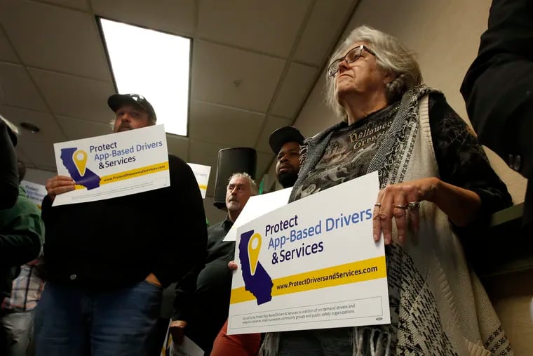 Carla Shrive, right, who drives for various gig into companies, joined other drivers to support a proposed ballot initiative challenging a recently signed California law that makes it harder for companies to label workers as independent contractors, in Sacramento, Calif., Oct. 29, 2019. A group called Protect App-Based Drivers and Services announced Tuesday that it will push a ballot initiative guaranteeing that drivers remain independent contractors but also receive a minimum wage and money for health insurance, echoing a nationwide debate on compensation for freelance and part-time workers.