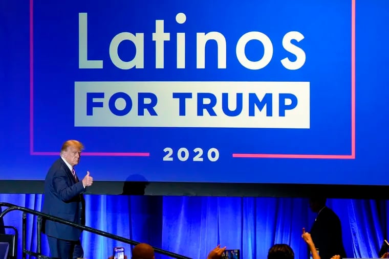 In this Sept. 14, 2020 file photo, President Donald Trump give a thumbs up to the cheering crowd after a Latinos for Trump Coalition roundtable in Phoenix. Polls show Biden with a commanding overall lead with Hispanic voters, a diverse group that defies neat political categories. Still, about 3 in 10 registered Latino voters nationwide back Trump, roughly consistent with how Latinos voted in 2018 congressional elections and in 2016. Latino men, like men of other races, support Trump more than Hispanic women.