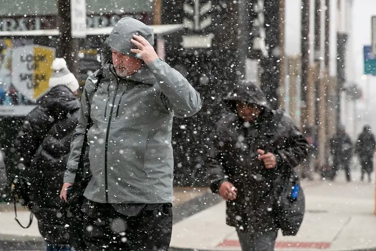 Pedestrians brace themselves against the snow during a snow squall in Center City in January. That turned out to be a winter highlight.