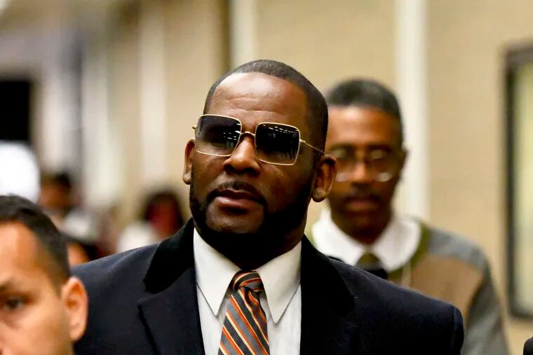 FILE - Musician R. Kelly, center, leaves the Daley Center after a hearing in his child support case on in 2019 in Chicago.