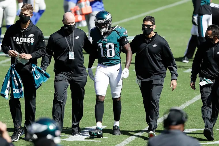 Eagles wide receiver Jalen Reagor leaves the field after injuring his thumb against the Rams on Sunday. He could be sidelined for weeks.