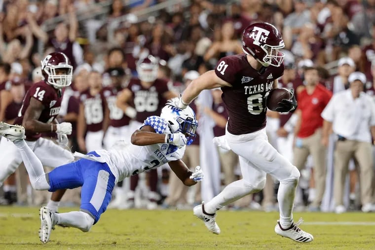 Texas A&M tight end Jace Sternberger (81) breaking a tackle attempt by Kentucky safety Jordan Griffin (3) as wide receiver Camron Buckley (14) looks on during an October game.