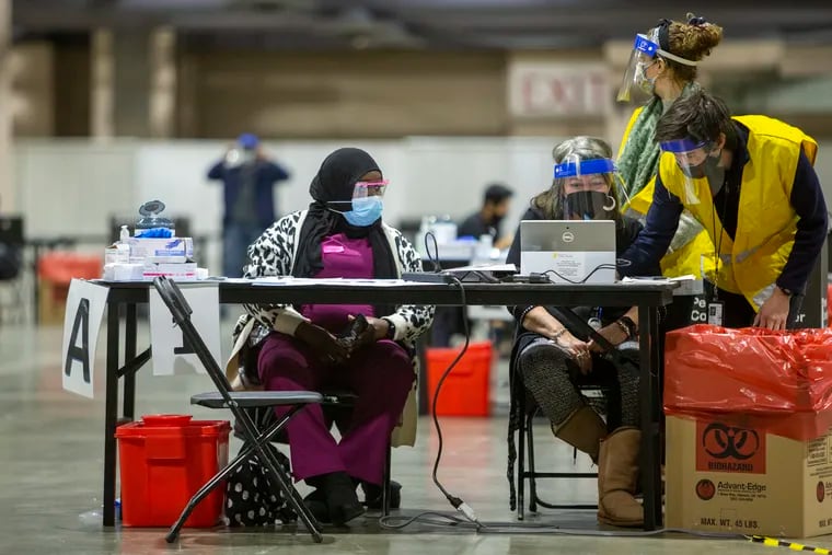 Health care workers waiting for someone to vaccinate at the city-run vaccine site at the Pennsylvania Convention Center on Wednesday.