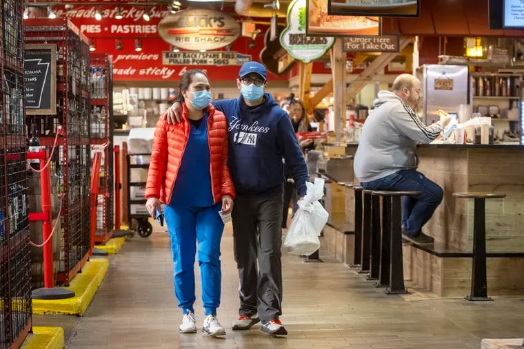 Patrons of Reading Terminal Market wearing and not wearing masks. The Philadelphia Department of Health announced it was scrapping its system of COVID-19 response criteria that triggered the mask mandate.