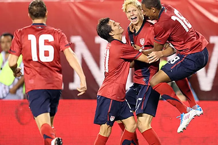 U.S. players celebrate after Robbie Rogers (left) scored the tying goal against Mexico. (Steven M. Falk/Staff Photographer)