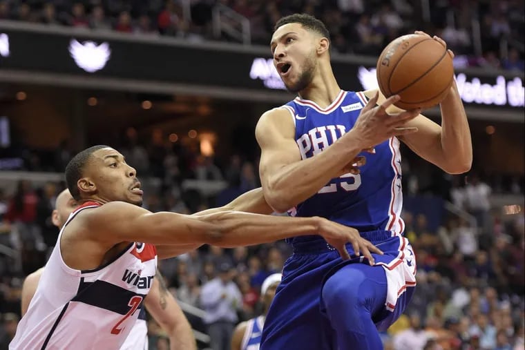 Ben Simmons (25) goes to the basket against Wizards forward Otto Porter Jr. during the first half Wednesday.