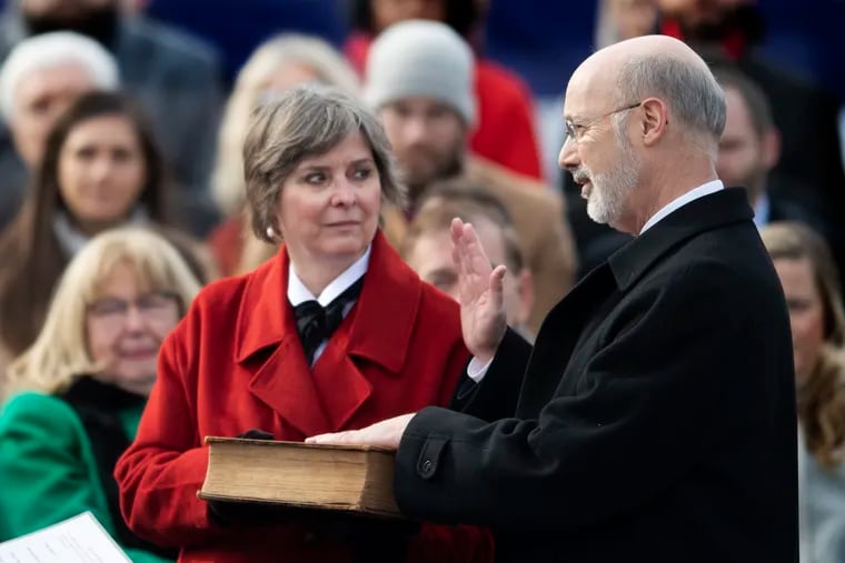 Pennsylvania Gov. Tom Wolf, accompanied by his wife Frances, takes the oath of office from Supreme Court chief Justice Thomas G. Saylor, as he is sworn in for his second term, Tuesday, Jan. 15, 2019, at the state Capitol in Harrisburg, Pa.