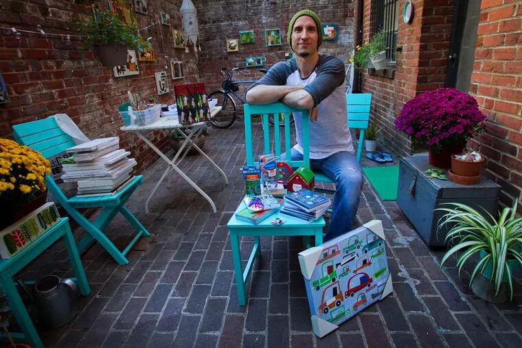 Artist Brian Love at his home and studio on Camac Street. Love has designed greeting cards, tissue boxes, and Macy's mailers, but returned to Philadelphia to serve small businesses.