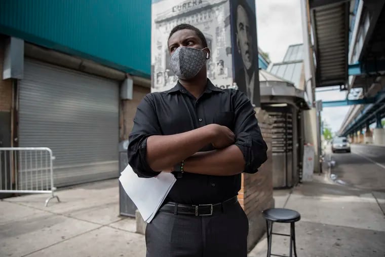 Jabari Jones, head of West Philly's largest business coalition, masked and frustrated at 52nd and Market last year after pandemic shutdowns and attacks on stores threatened neighborhood commerce. Now he worries that new city guidelines urging a return to masks in response to a recent spike in Covid-19 cases could discourage returning patrons