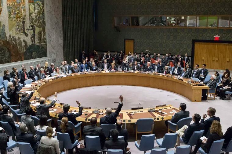Members of the U.N. Security Council voting on the Israeli settlement resolution during Friday's session at headquarters in New York.