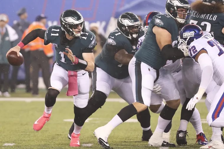Eagles quarterback Carson Wentz scramble with the football against the New York Giants in the first-quarter on Thursday, October 11, 2018 in East Rutherford, NJ. MICHAEL BRYANT / Staff Photographer