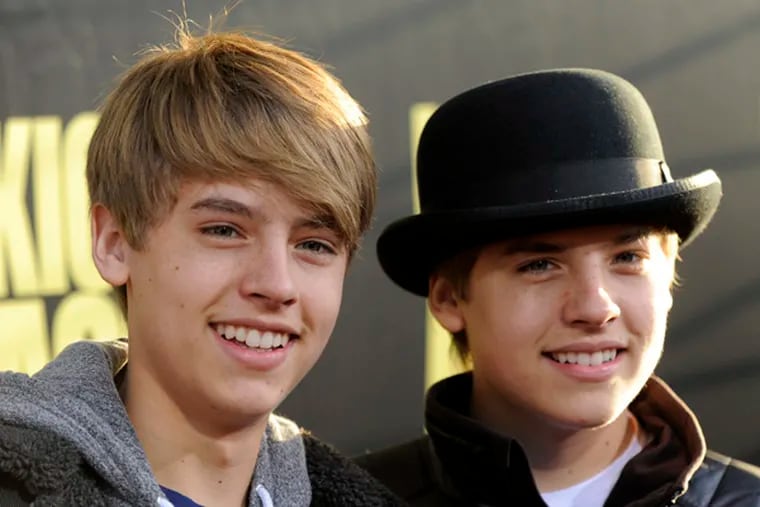 Brothers Cole, left, and Dylan Sprouse arrive at the premiere of the film "Kick-Ass" in Los Angeles, Tuesday, April 13, 2010. (AP Photo/Chris Pizzello)