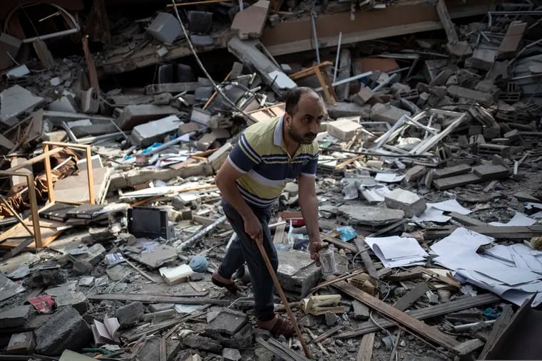 A Palestinian man inspects the damage of a house destroyed by an early morning Israeli airstrike, in Gaza City, on Tuesday.