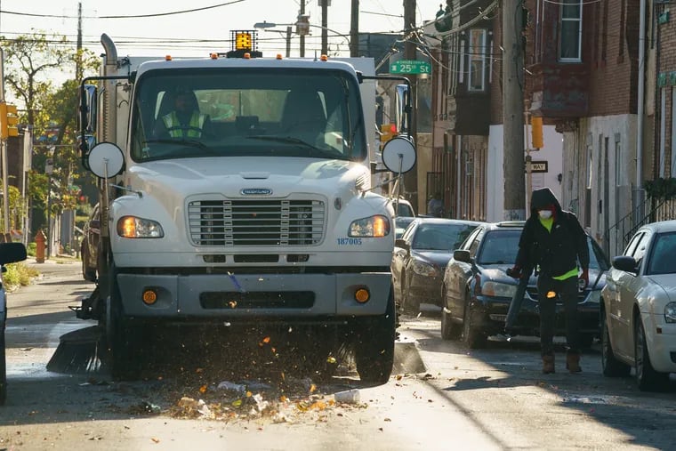 A street sweeping crew works near at 24th and York, in Philadelphia, October 4, 2019.