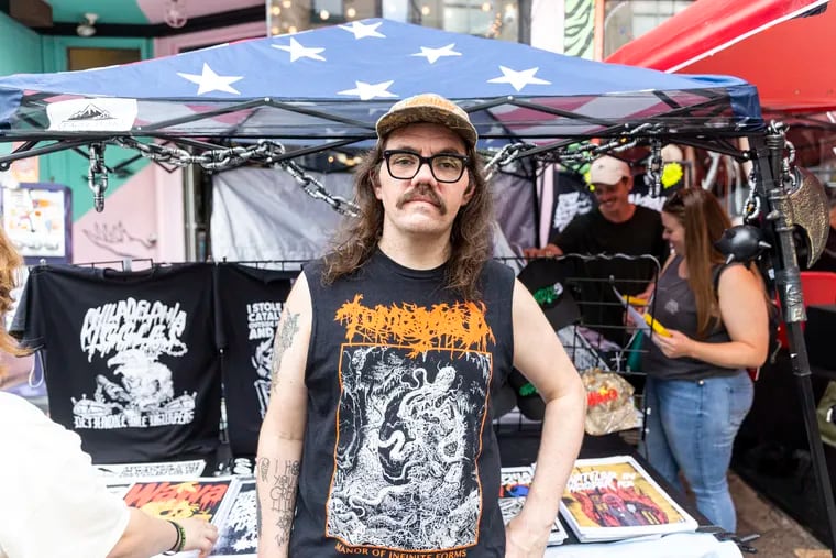 Jim Anderson, 35, of Roxborough, Pa., Graphic Designer and owner of GrimGrimGrim, poses for a portrait at his tent during a popup event in South Philadelphia, Pa., on Saturday, Aug., 26, 2023.