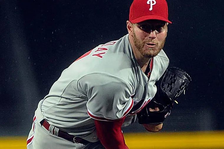 Phillies pitcher Roy Halladay works against the Atlanta Braves during the first inning. (John Amis/AP)